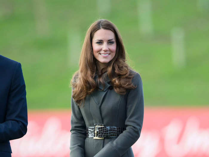 The then-Duchess of Cambridge looked cozy in a green Reiss coat at a football launch event.