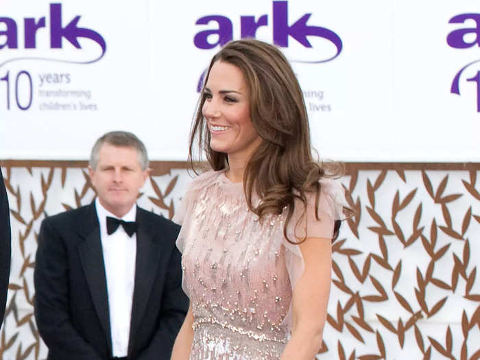 Kate shimmered in this embellished pink gown with sheer sleeves.