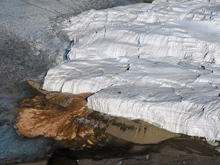 A large glacier in Antarctica produces a bright red river that oozes out of the ice, aptly named Blood Falls. Why the reddish water pours out of Antarctica