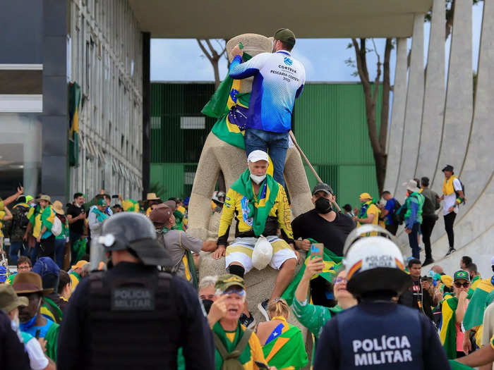 Some demonstrators in Brazil hung flags and defaced monuments and statues outside the government buildings.