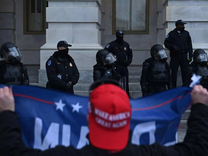 Much like how pro-Trump supporters waved Trump flags at the US Capitol Police on January 6.