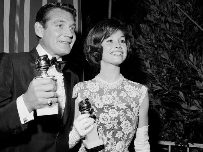 February 1965: Mary Tyler Moore wore a strapless dress covered by a floral overlay.