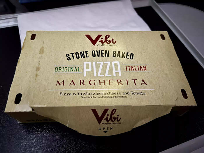 I slept on and off for about two hours before waking up for the second meal service, which was about one hour before landing.  We were given a choice of pizza or a chicken sandwich with honey mustard.