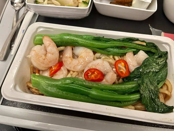 The first meal was served about 30 minutes into the flight, and there were three options: a beef dish, chicken fried rice, and prawns — I chose the latter.