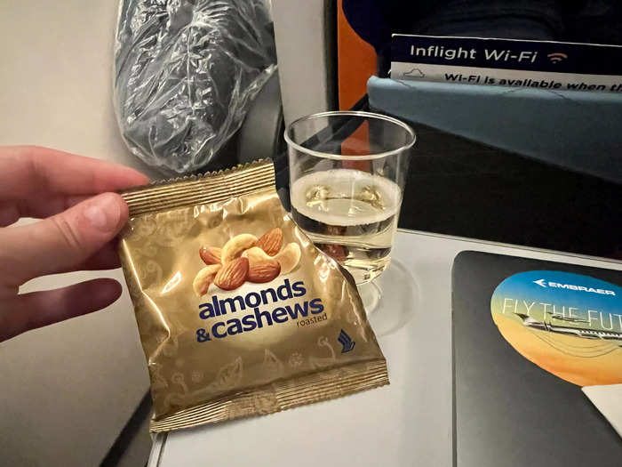 About 10 minutes after takeoff — which was right on time — the cabin crew came around with nuts, as well as drinks like champagne, orange juice, water, wine, and beer.