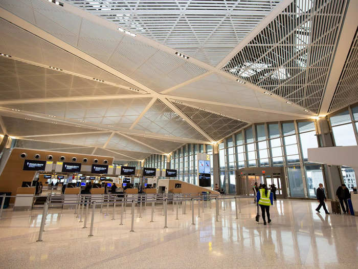 The sprawling check-in hall had tall ceilings and white walls that reflected the bright natural light on a cloudy day.