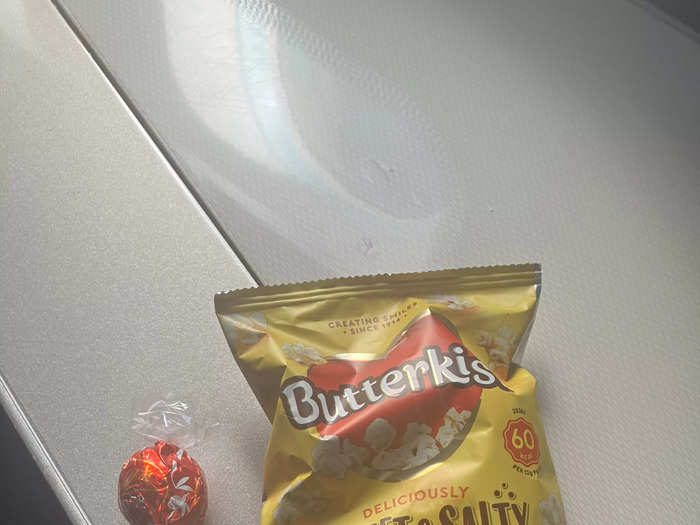 Two and a half hours after breakfast was served, the flight attendant came around with a basket of snacks. I chose some popcorn and a chocolate truffle.