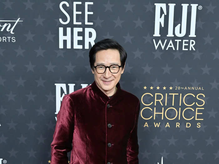 Ke Huy Quan walked the carpet in a velvet suit jacket and black pants.