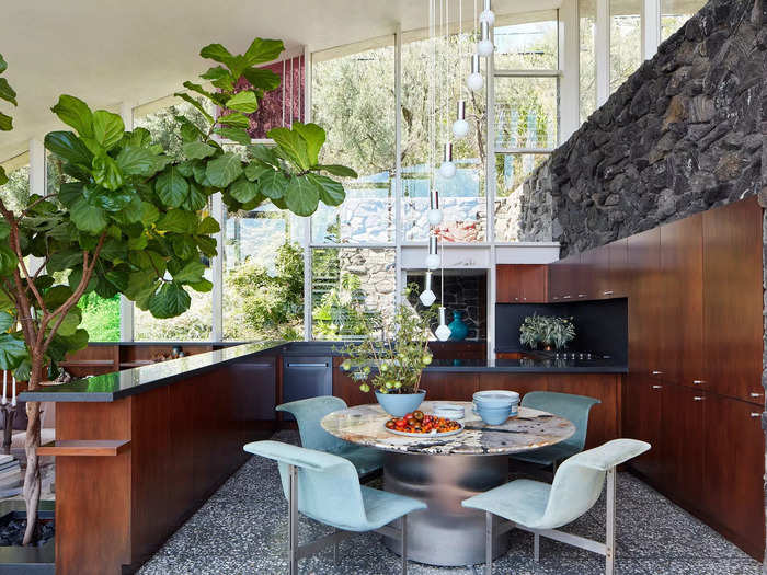 The living and eating areas are all connected under the curved roof, and both parts of the home have incredible views of the canyon.