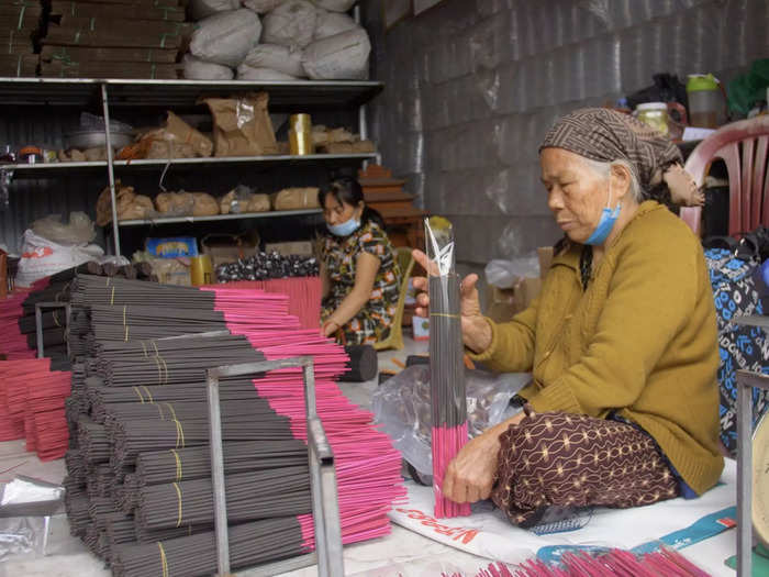 Once completely dried, the dyed incense sticks are fed into machines to be coated with the incense powder. Finally, workers package the dried and perfected sticks into plastic, ready for distribution.