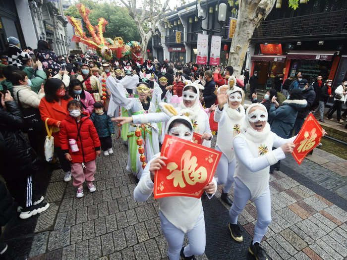 In Hangzhou, China, festival-goers sported "Jade Rabbit" costumes at a street parade where they greeted tourists.