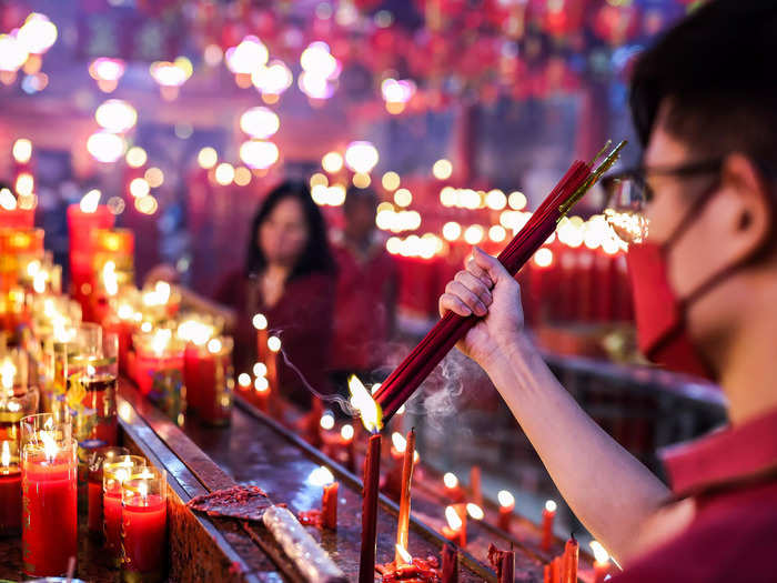 In Bekasi, Indonesia, a man lit incense and prayed for good fortune at the Hok Lay Kiong temple.
