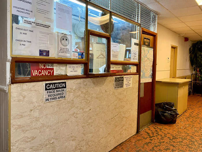 In the lobby, I walked up to a desk behind a half-window wall next to a few trash canisters, with no seating.