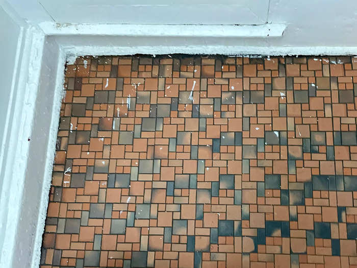 Walking up the stairs, I noticed that the tiles on the floor were weathered and dirty, and several were missing.