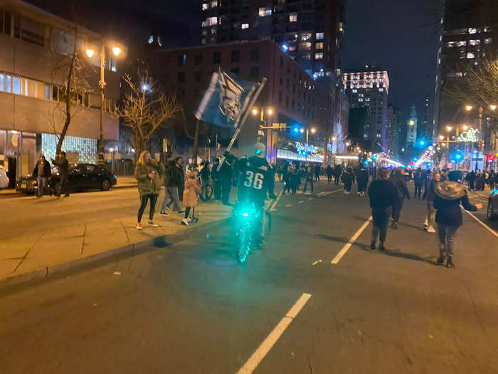 In more open parts of the streets, cyclists and scooters rode by waving flags.