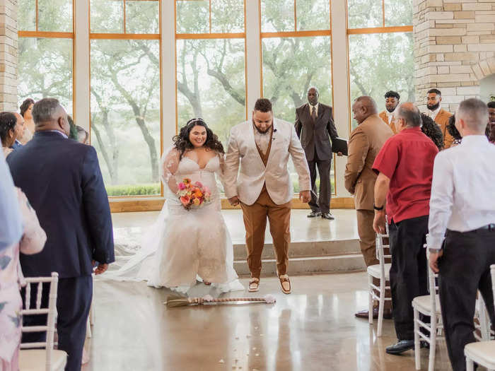 AnDre and Elise jumped the broom at the end of their wedding ceremony because of its significance to AnDre