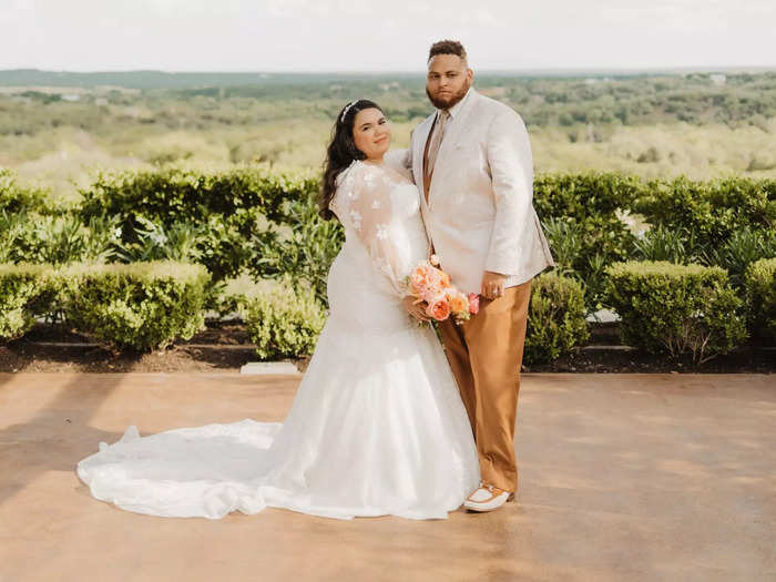 AnDre opted for a non-traditional wedding ensemble that featured a subtly patterned jacket and russet brown pants.