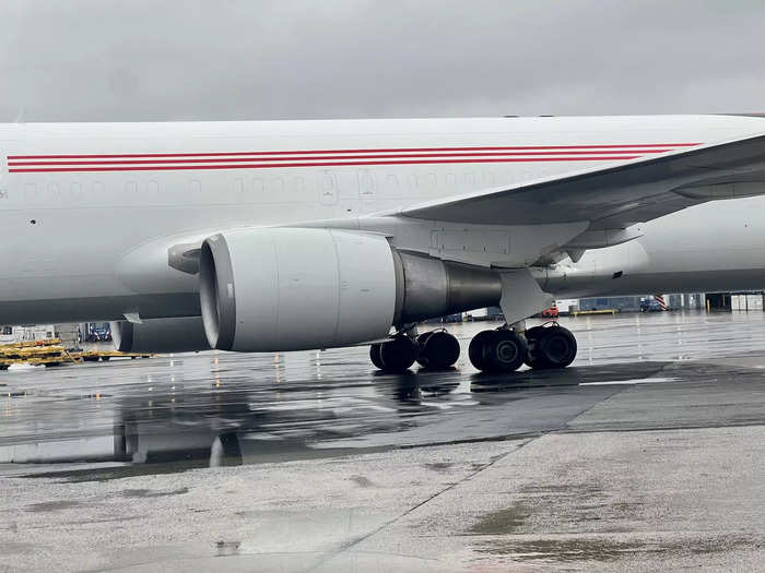 While the plane was being towed, I noticed the old passenger windows and emergency doors, which were painted over during the freighter conversion, were still faintly visible.