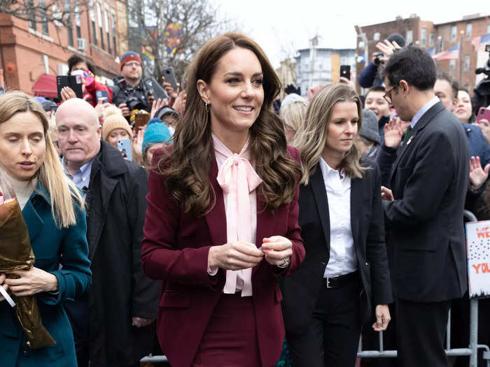 Kate donned a burgundy suit with a 1970s twist on a visit to Boston, Massachusetts in December 2022.