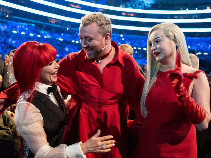Shania Twain, Sam Smith, and Kim Petras, who all matched in bright red, shared a moment together after Smith and Petras
