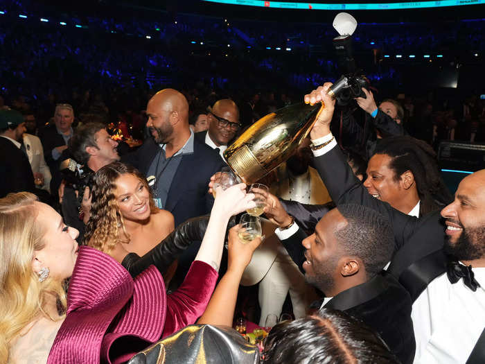 The "Break My Soul" singer was later seen celebrating her incredible feat with a magnum of champagne alongside husband Jay Z, Adele, Rich Paul, and Juan "OG" Perez.