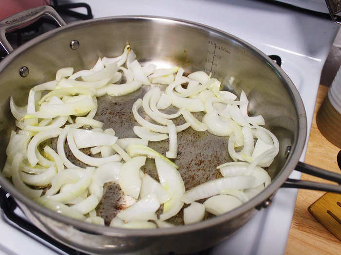 Add jarred sauce to a pan of onions and garlic.