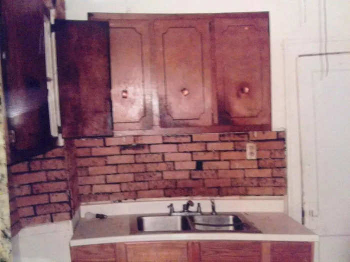 The house was in a state of total disrepair when he bought it. Paint was peeling off the walls, wires were hanging loose, and the kitchen appliances were covered in rust.