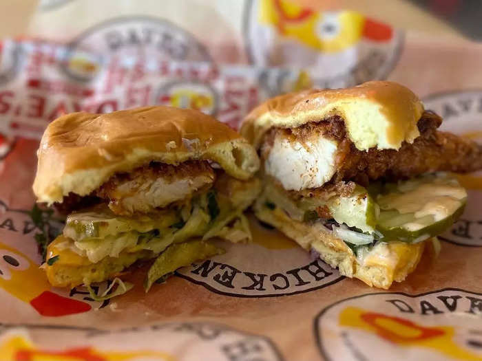 The soft spongy potato buns layered with the spicy tender, crinkle-cut pickles, slaw, and Dave