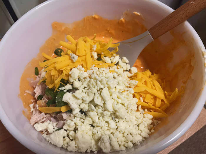 I then added the chopped chicken, blue-cheese crumbles, cheddar cheese, and scallions into the sauce.