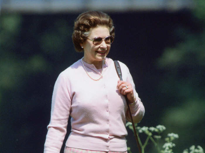 The Queen even coordinated her more casual outfits, one of which she wore while walking the grounds of Windsor Castle in 1982.