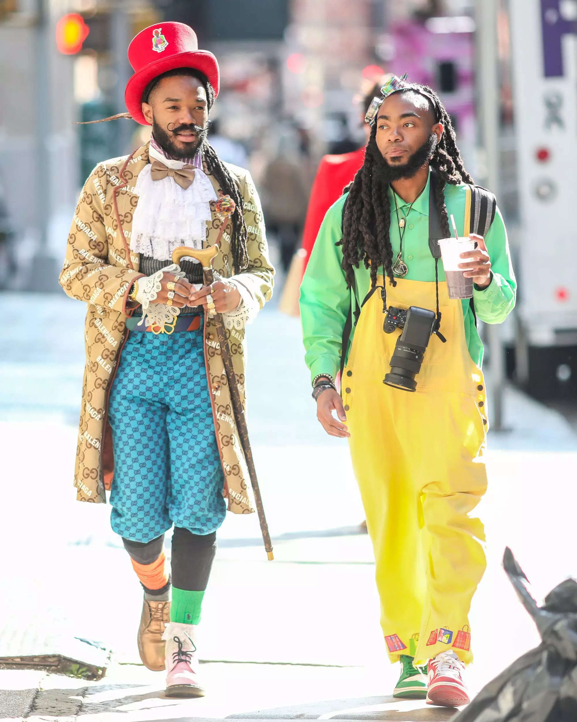 Two people in colorful outfits walk down the street in New York City