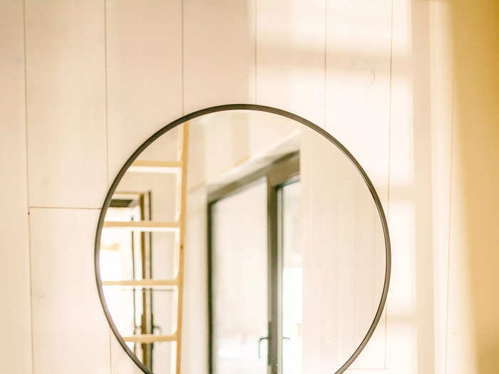 The bathroom also has matte black fixtures, which nicely contrast the white walls and lighter-colored floors.