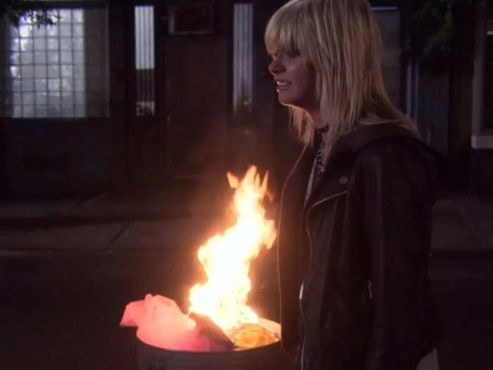 Jenny just watches Agnes light her designs on fire.