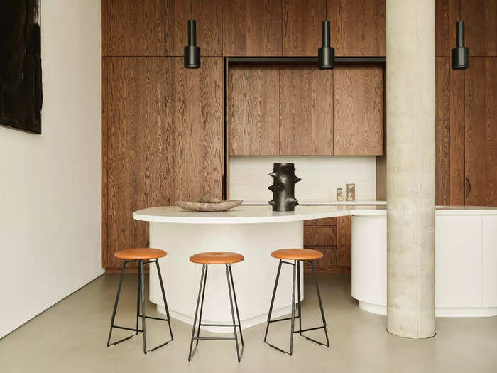 The kitchen cabinets are made of wood, giving an earthy feel to the minimalist design.