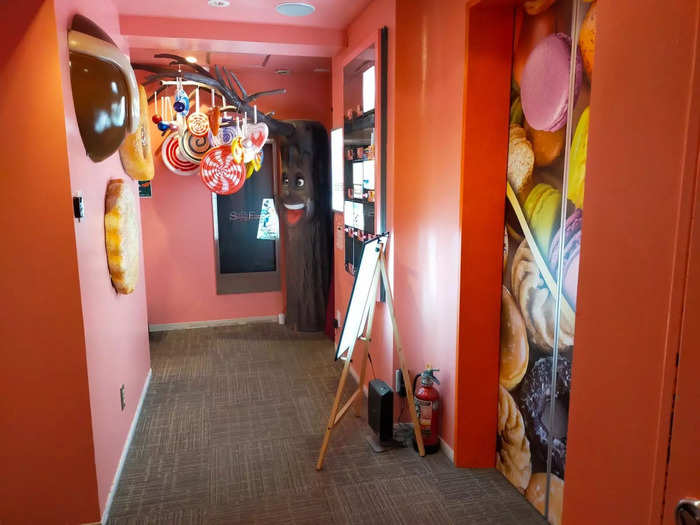 I entered Sweets Hotel Ruby through a pink, windowless hallway that had fairground music filling the air.