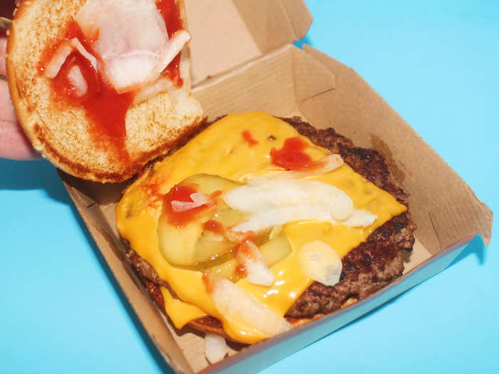 The Quarter Pounder with cheese comes with one quarter-pound burger patty, two slices of American cheese, onions, pickles, mustard, and ketchup.