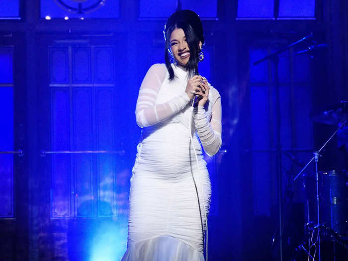 Cardi B chose a long-sleeve, semi-sheer white dress to share that she was expecting on "Saturday Night Live" in 2018.