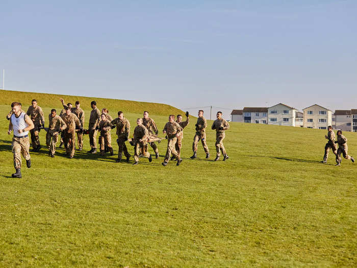 They raise their hands when they want to swap out as a signal for one of their teammates running behind to come and relieve them of their duty...