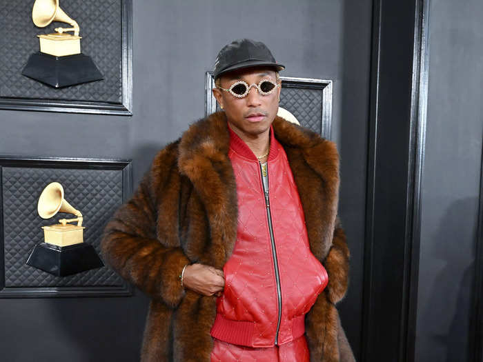 A week before his new role at Louis Vuitton was announced, Williams arrived at the 2023 Grammys in a ruby-red leather look layered under a faux-fur jacket.