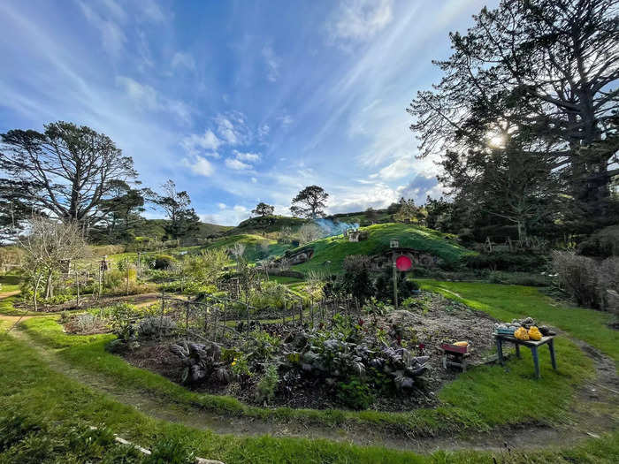 The reveal felt magical. Built into a hillside were bright, circular doors and hobbit homes. Smoke billowed from tiny chimneys and a vegetable garden sat at the bottom of the hill.