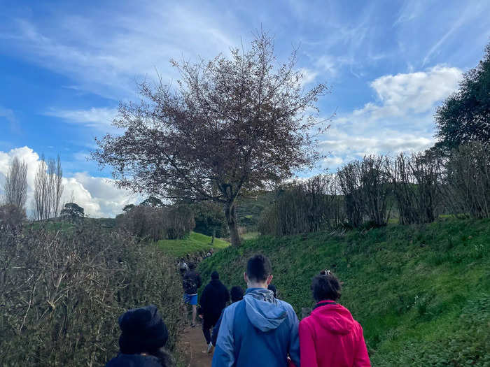 Our group of about 20 people walked along a muddy, narrow path. As I turned a corner, Hobbiton finally came into view.