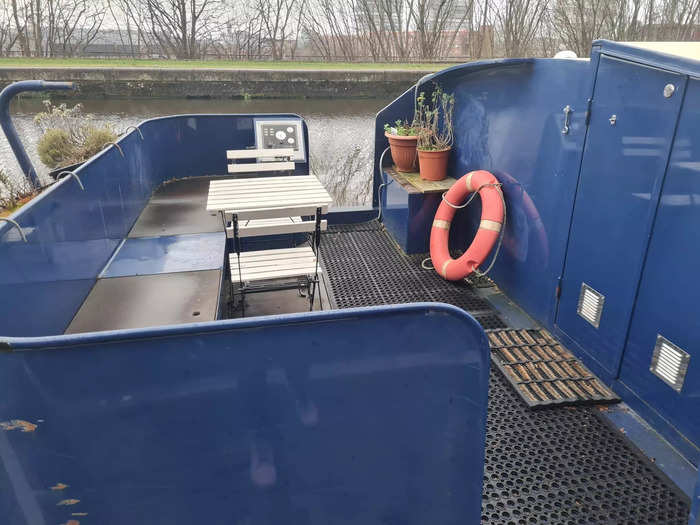 The houseboat is 12 feet wide and has two bedrooms, two bathrooms, a living room, and a kitchen.