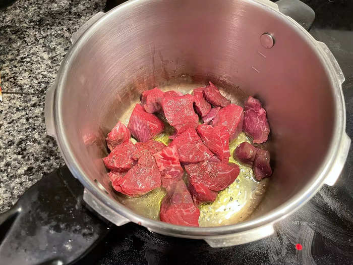 Let the olive oil heat up, then throw in the meat cubes.