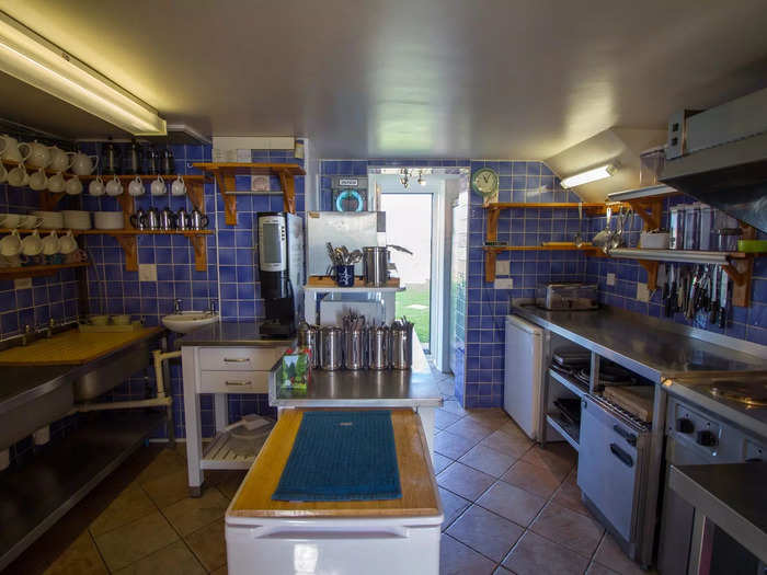 The kitchen, which also looks out over the English Channel, has royal blue wall tiles and cabinets made from pine and oak.