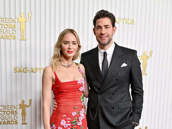 Emily Blunt arrived at the SAG Awards in a red floral dress, while John Krasinski wore a striped suit.