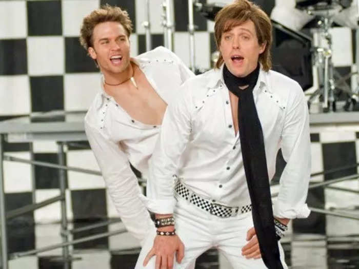 Hugh Grant and Scott Porter give it their all as PoP! in "Music and Lyrics."