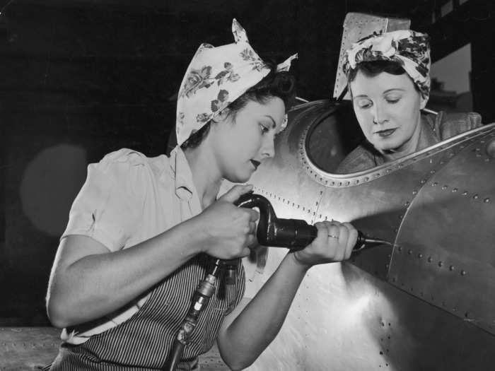 Many women working in military factories were photographed wearing bandanas to tie back their hair.