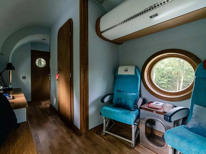 Even the sitting area of the tiny house is furnished with actual airplane seats.