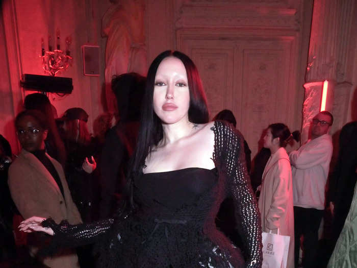 Noah Cyrus seemingly channeled Morticia Addams on the second day of Paris Fashion Week in a black gown with a lace peplum bodice.