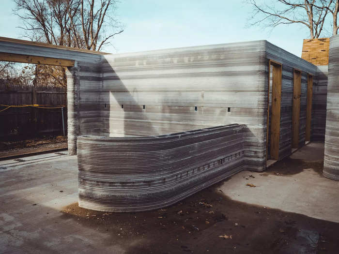 The printer can make some unique geometric shapes, too. For example this curved cement slab protruding from the wall will be a kitchen counter peninsula once the house is finished.